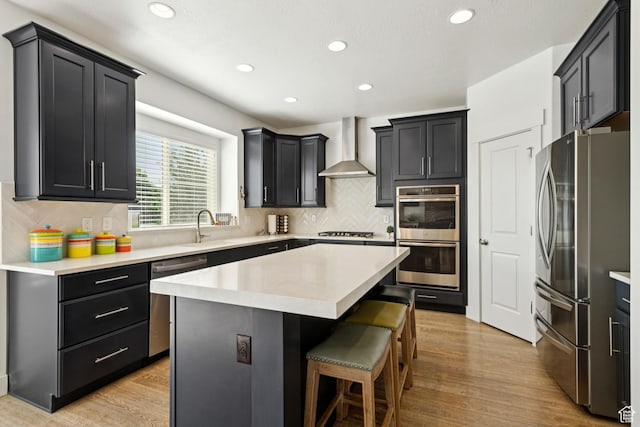 319 S 300 E, Midway, UT 84049 - kitchen with appliances with stainless steel finishes, wall chimney exhaust hood, a center island, a kitchen breakfast bar, and recessed lighting