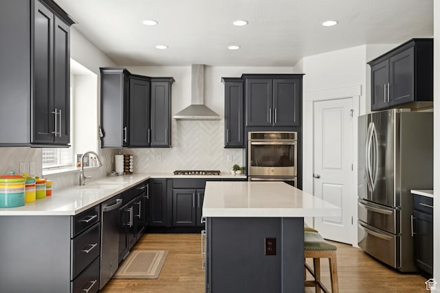 319 S 300 E, Midway, UT 84049 - kitchen featuring stainless steel appliances, wall chimney range hood, a kitchen island, decorative backsplash, and a breakfast bar area