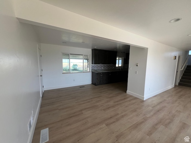 2955 N 7600 W, Corinne, UT 84307 - unfurnished living room featuring stairway and light wood finished floors