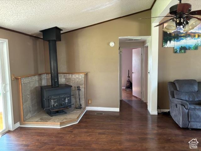 290 E 800 S, Roosevelt, UT 84066 - unfurnished living room featuring wood finished floors, crown molding, a wood stove, a ceiling fan, and a textured ceiling