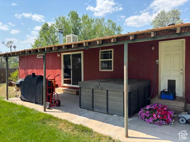 290 E 800 S, Roosevelt, UT 84066 - rear view of property with a hot tub, a patio, and entry steps