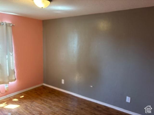 290 E 800 S, Roosevelt, UT 84066 - spare room featuring dark wood-style flooring and baseboards