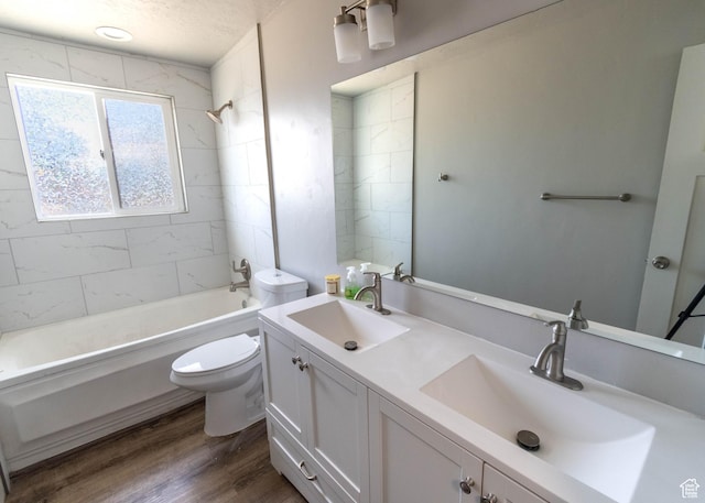 9446 S Barium St E, Sandy, UT 84094 - full bathroom featuring double vanity, bathtub / shower combination, wood finished floors, and a textured ceiling