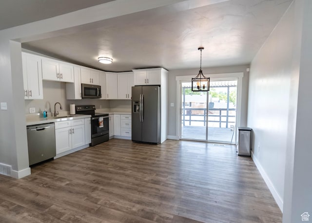 9446 S Barium St E, Sandy, UT 84094 - kitchen featuring appliances with stainless steel finishes, light countertops, white cabinets, and dark wood-style floors