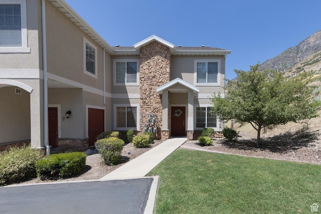 1183 N Canyon Meadow Dr E Unit 9, Provo, UT 84606 - townhome / multi-family property with stone siding, stucco siding, a front lawn, and a mountain view