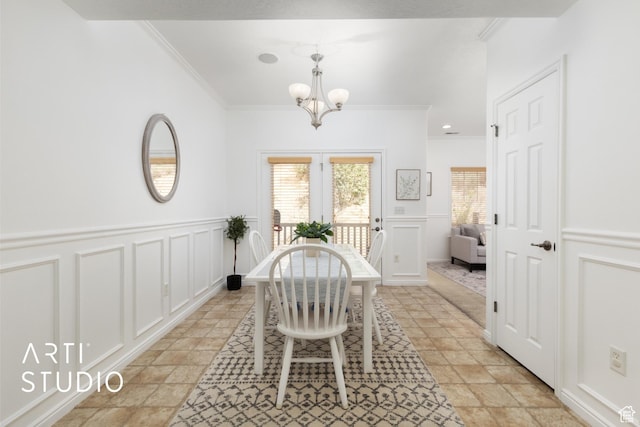 1183 N Canyon Meadow Dr E Unit 9, Provo, UT 84606 - dining area featuring crown molding, a decorative wall, a chandelier, light stone finish floors, and a wainscoted wall