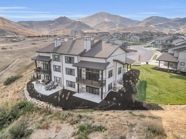 864 W Eland Cir, Heber City, UT 84032 - rear view of house featuring a balcony, a chimney, a mountain view, a patio, and a shingled roof