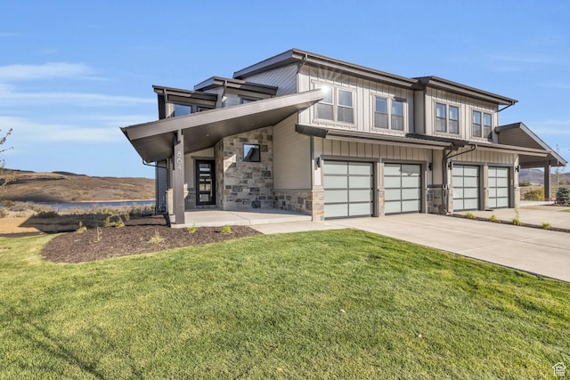 864 W Eland Cir, Heber City, UT 84032 - view of front facade featuring concrete driveway, a garage, a front lawn, and stone siding