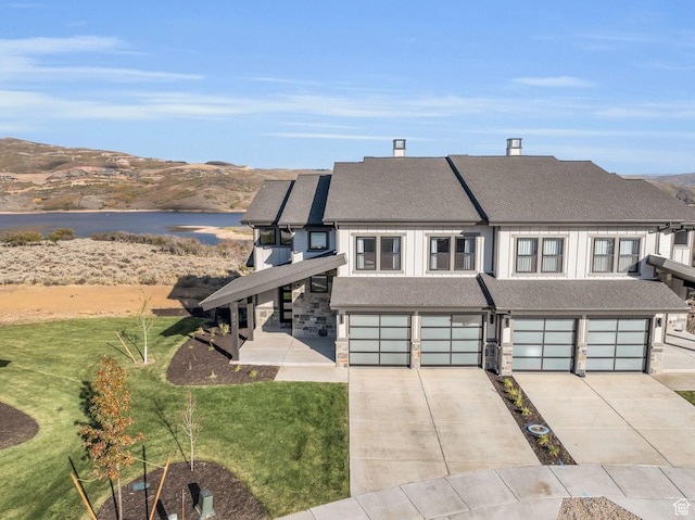 864 W Eland Cir, Heber City, UT 84032 - view of front of home with an attached garage, driveway, a front yard, a shingled roof, and a water view