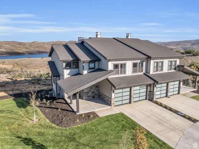 864 W Eland Cir, Heber City, UT 84032 - view of front facade featuring driveway, an attached garage, a front yard, roof with shingles, and a water and mountain view