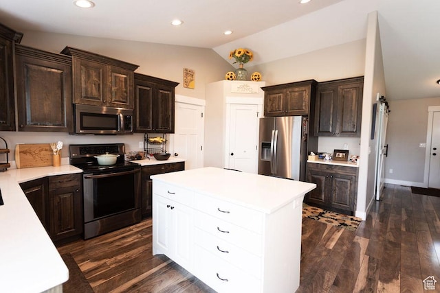 1285 W 1100 N, Farr West, UT 84404 - kitchen with appliances with stainless steel finishes, vaulted ceiling, light countertops, dark brown cabinets, and a center island