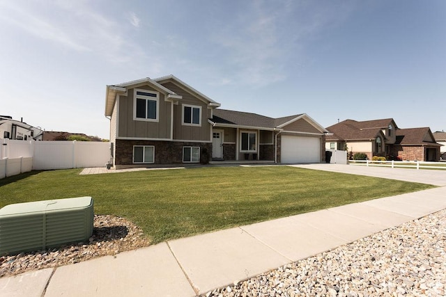 1285 W 1100 N, Farr West, UT 84404 - view of front of property featuring driveway, an attached garage, board and batten siding, and stone siding