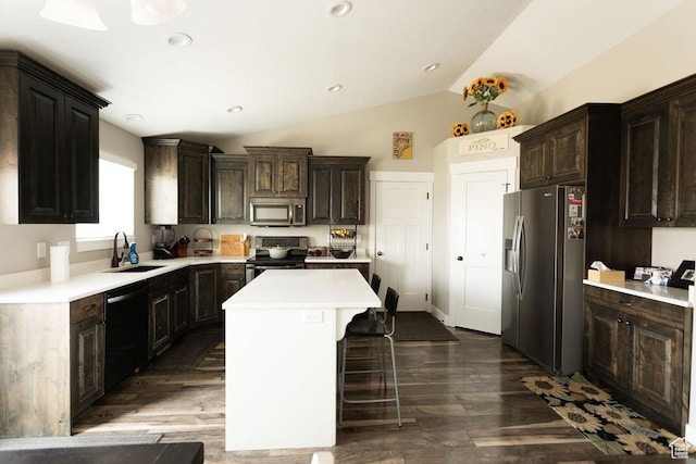 1285 W 1100 N, Farr West, UT 84404 - kitchen featuring stainless steel appliances, a kitchen island, light countertops, vaulted ceiling, and dark wood finished floors