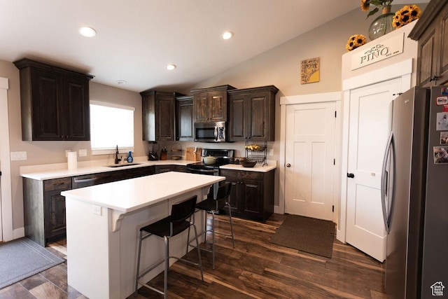 1285 W 1100 N, Farr West, UT 84404 - kitchen with stainless steel appliances, a breakfast bar, dark brown cabinets, light countertops, and lofted ceiling