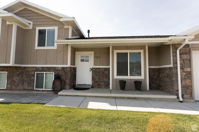 1285 W 1100 N, Farr West, UT 84404 - view of exterior entry featuring stone siding, a porch, board and batten siding, and a yard