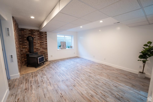 2087 E Weeping Willow Way N, Eagle Mountain, UT 84005 - unfurnished living room with a wood stove, wood finished floors, a paneled ceiling, and recessed lighting