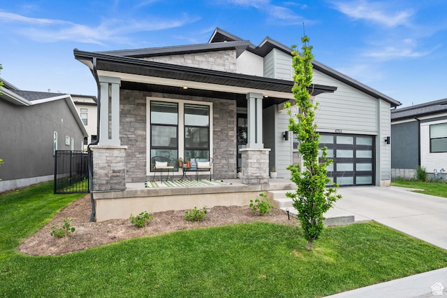 4753 W Mossley Dr, Herriman, UT 84096 - view of front of property featuring covered porch, stone siding, concrete driveway, and a front yard