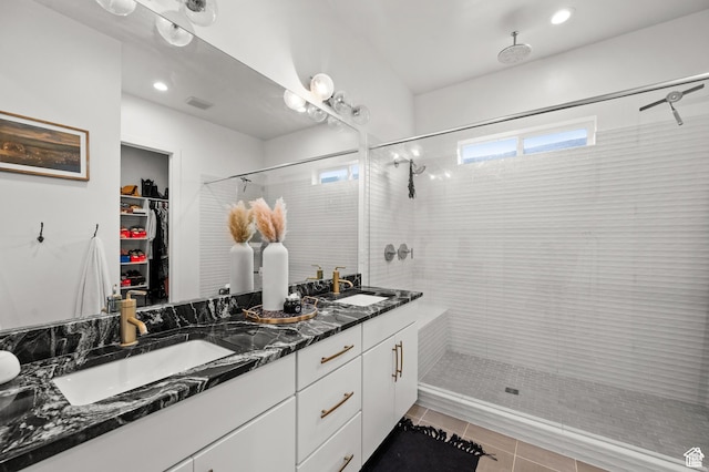 4753 W Mossley Dr, Herriman, UT 84096 - full bathroom with double vanity, a shower stall, a spacious closet, tile patterned floors, and recessed lighting