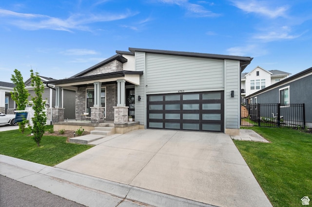 4753 W Mossley Dr, Herriman, UT 84096 - contemporary home with covered porch, stone siding, concrete driveway, and a garage