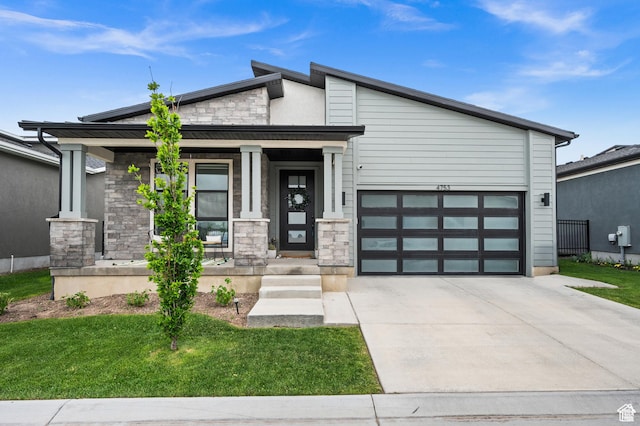 4753 W Mossley Dr, Herriman, UT 84096 - view of front of property featuring stone siding, concrete driveway, a garage, and a front yard