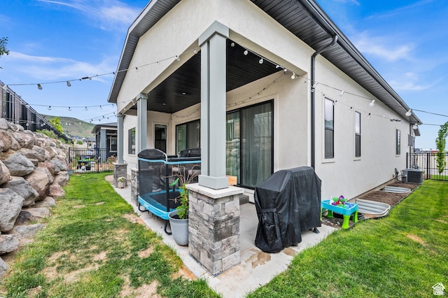 4753 W Mossley Dr, Herriman, UT 84096 - rear view of property with stucco siding and a patio