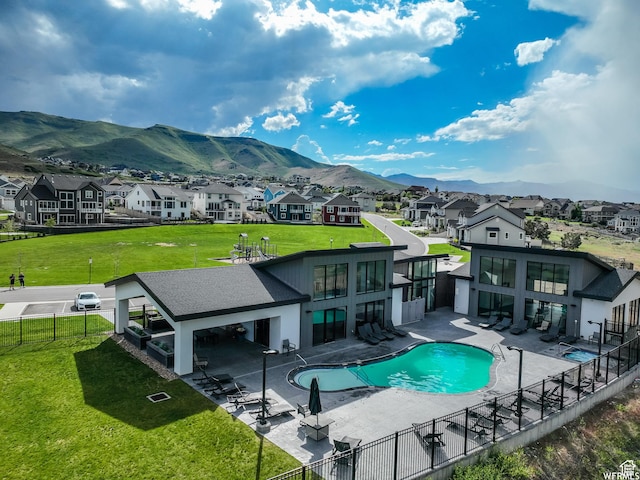 4753 W Mossley Dr, Herriman, UT 84096 - back of house featuring a residential view, a fenced backyard, a mountain view, and a patio