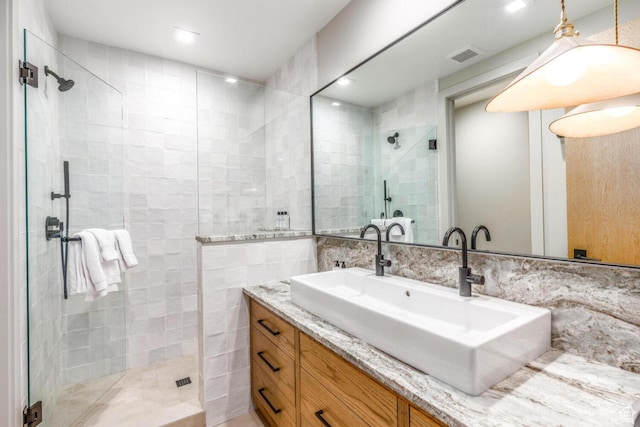 7615 E Stardust Ct Unit 319H, Heber City, UT 84032 - bathroom featuring a shower stall, vanity, and tile walls