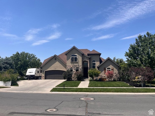 12768 S Whisper Bend Dr E, Draper, UT 84020 - view of front of property with driveway, stucco siding, stone siding, a front yard, and a garage