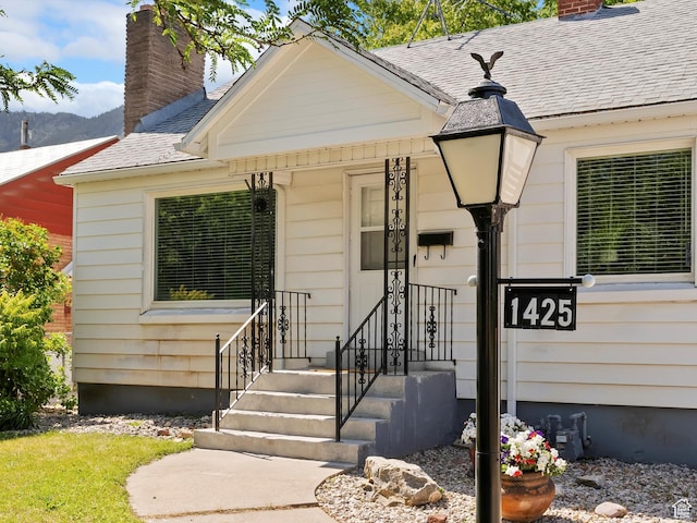 1425 E 22nd St S, Ogden, UT 84401 - view of front of property with a chimney, a shingled roof, and a mountain view