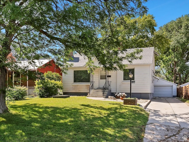 1425 E 22nd St S, Ogden, UT 84401 - view of property hidden behind natural elements featuring a garage, a front lawn, an outdoor structure, and a shingled roof