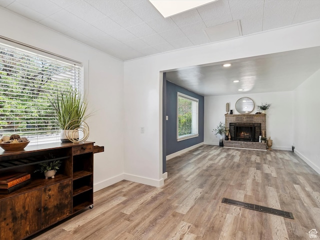 1425 E 22nd St S, Ogden, UT 84401 - living room with light wood-type flooring and a brick fireplace