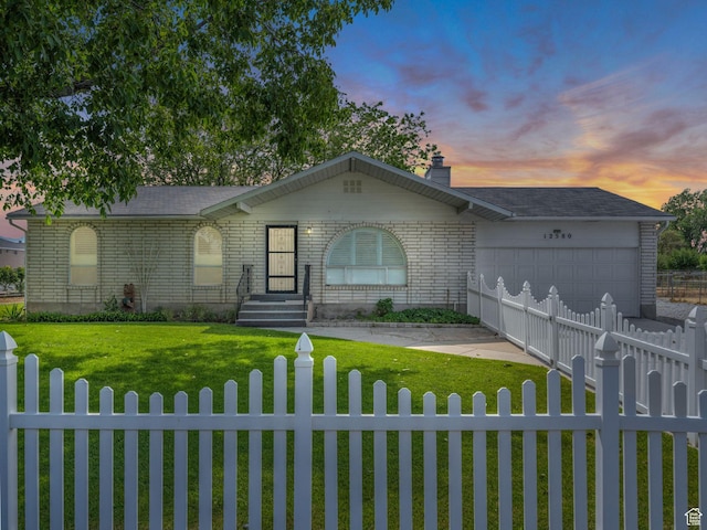 12580 S Janice Dr, Riverton, UT 84065 - ranch-style house featuring a fenced front yard, a garage, and brick siding
