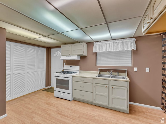 12580 S Janice Dr, Riverton, UT 84065 - kitchen with gas range gas stove, under cabinet range hood, light wood-style floors, and light countertops
