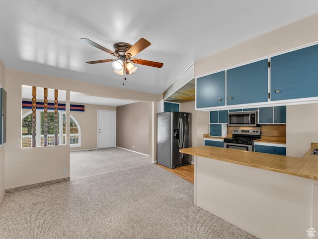12580 S Janice Dr, Riverton, UT 84065 - kitchen with appliances with stainless steel finishes, blue cabinets, ceiling fan, and light countertops