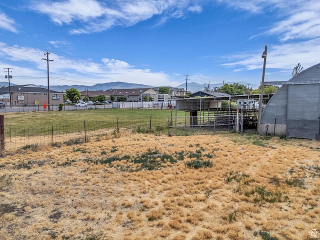 12580 S Janice Dr, Riverton, UT 84065 - view of yard featuring a mountain view, an outbuilding, an exterior structure, and a residential view