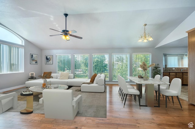 4940 S Atwood Blvd, Murray, UT 84107 - living area with lofted ceiling, plenty of natural light, light wood-type flooring, a chandelier, and a ceiling fan