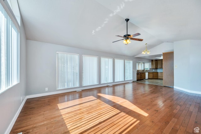 4940 S Atwood Blvd, Murray, UT 84107 - unfurnished living room with vaulted ceiling, plenty of natural light, hardwood / wood-style floors, and ceiling fan