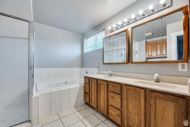 4940 S Atwood Blvd, Murray, UT 84107 - bathroom with double vanity, a shower stall, a garden tub, and tile patterned floors