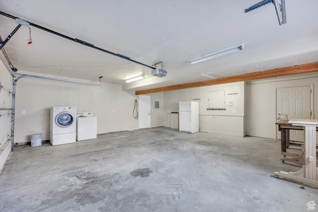 4940 S Atwood Blvd, Murray, UT 84107 - garage featuring freestanding refrigerator and washer and clothes dryer