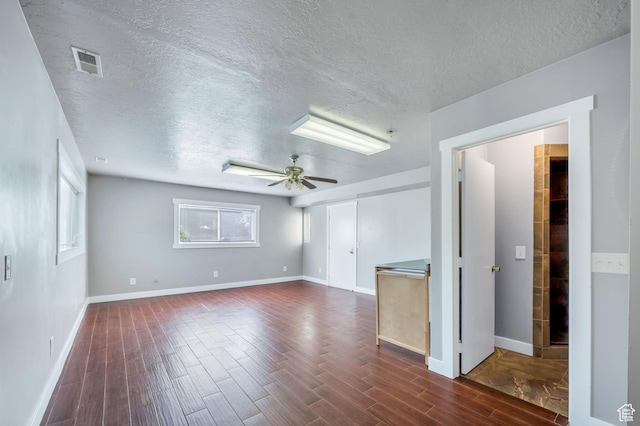 4940 S Atwood Blvd, Murray, UT 84107 - spare room featuring a textured ceiling, ceiling fan, and dark wood-type flooring