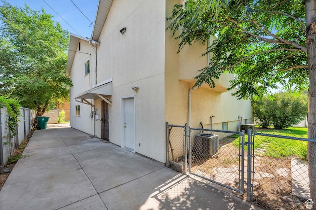 4940 S Atwood Blvd, Murray, UT 84107 - view of side of property featuring stucco siding, a gate, and a patio area