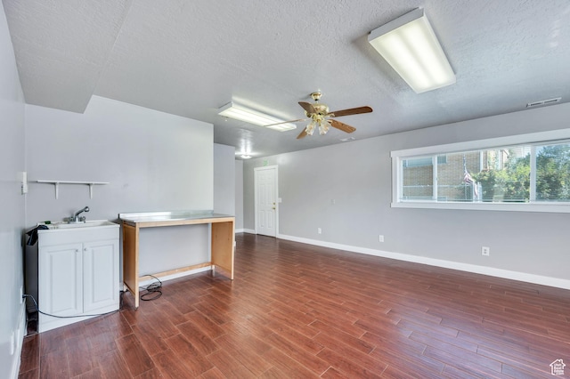 4940 S Atwood Blvd, Murray, UT 84107 - unfurnished living room with a textured ceiling, wood finished floors, and ceiling fan
