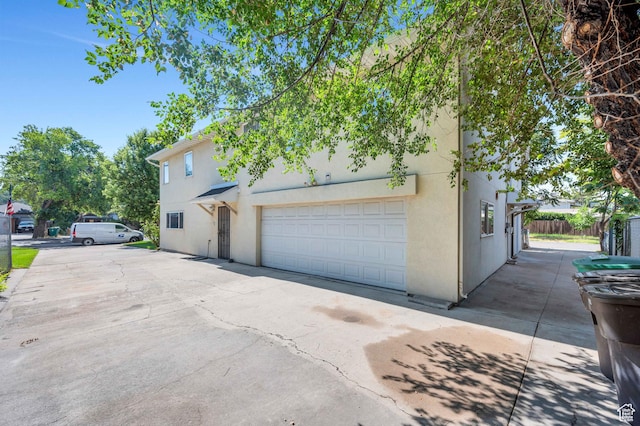 4940 S Atwood Blvd, Murray, UT 84107 - view of front of house featuring stucco siding and driveway