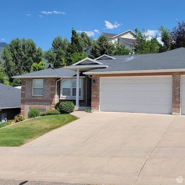 5272 S 1035 E, South Ogden, UT 84403 - view of front facade featuring brick siding, concrete driveway, an attached garage, and a front yard