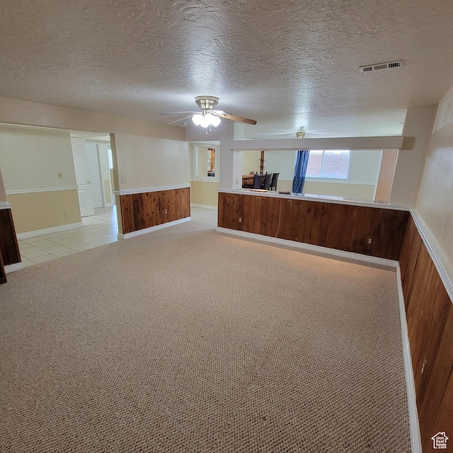 5272 S 1035 E, South Ogden, UT 84403 - basement featuring a textured ceiling, a ceiling fan, a wainscoted wall, wooden walls, and light colored carpet
