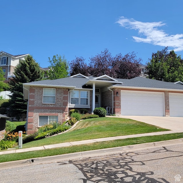 5272 S 1035 E, South Ogden, UT 84403 - ranch-style home with brick siding, a garage, concrete driveway, and a front lawn