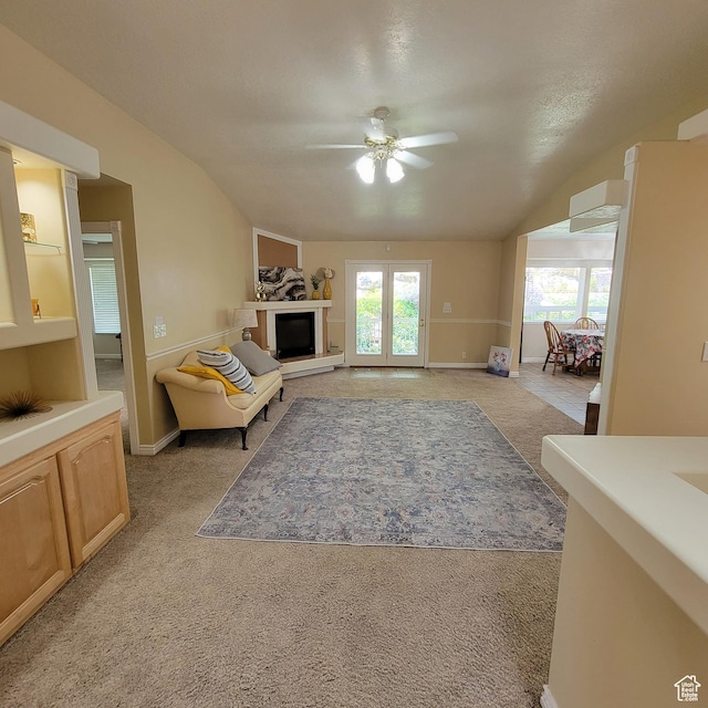 5272 S 1035 E, South Ogden, UT 84403 - living room featuring ceiling fan, light colored carpet, vaulted ceiling, and a fireplace with raised hearth