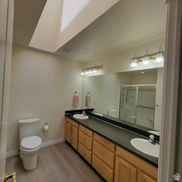 5272 S 1035 E, South Ogden, UT 84403 - full bathroom with double vanity, a stall shower, wood finished floors, and a textured ceiling