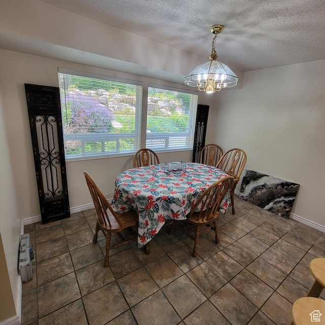 5272 S 1035 E, South Ogden, UT 84403 - dining area featuring a chandelier and a textured ceiling