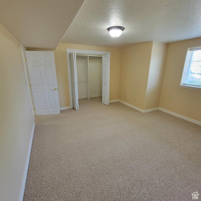 5272 S 1035 E, South Ogden, UT 84403 - unfurnished bedroom featuring light colored carpet, a closet, and a textured ceiling